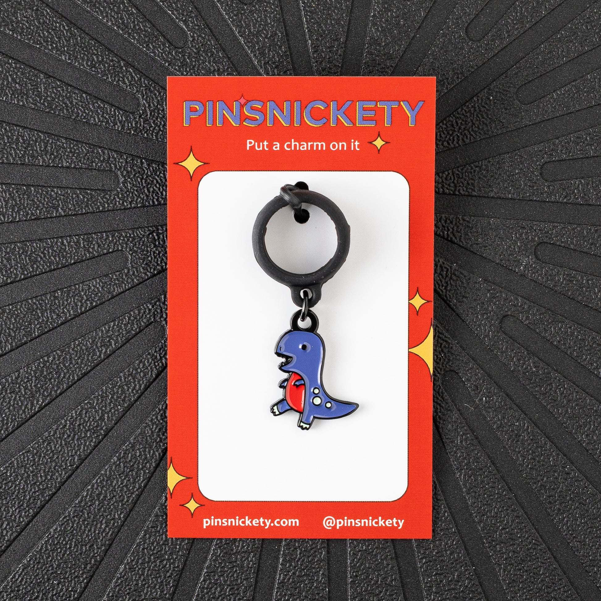 Pinsnickety T-Rex crop charm in front of a black background