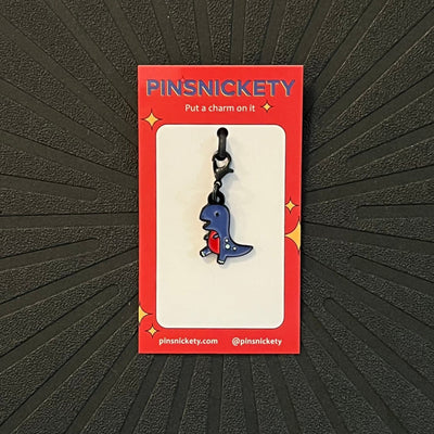 Pinsnickety T-Rex braid and bridle charm on a black background