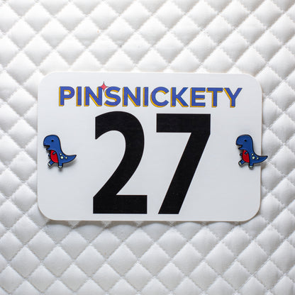 pinsnickety t-rex horse show number pins on a saddle pad