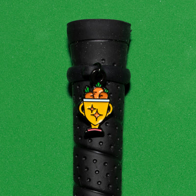 Pinsnickety Trophy crop charm on a whip handle in front of a colored background