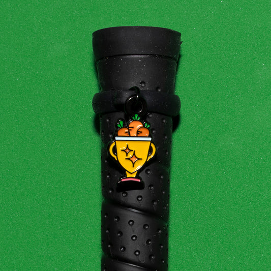 Pinsnickety Trophy crop charm on a whip handle in front of a colored background