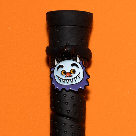 Pinsnickety Wild Thing crop charm on a whip handle in front of a colored background