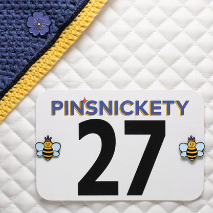 pinsnickety purple poppy horse show number pin on a bonnet and queen bee equestrian pins on a saddle pad