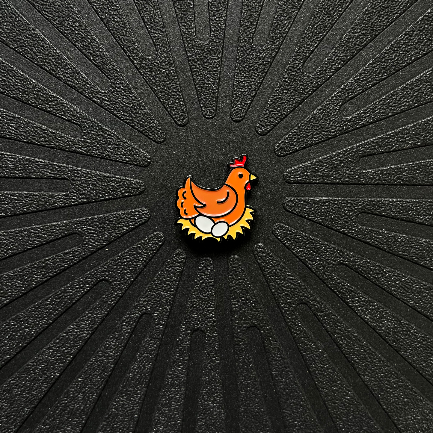Pinsnickety chicken horse show number pin on a black background