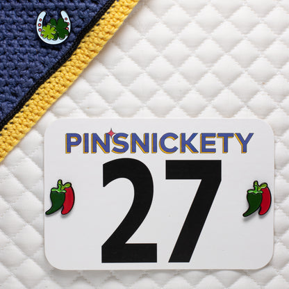 pinsnickety chili pepper horse show number pins on a saddle pad and horseshoe pin on a bonnet