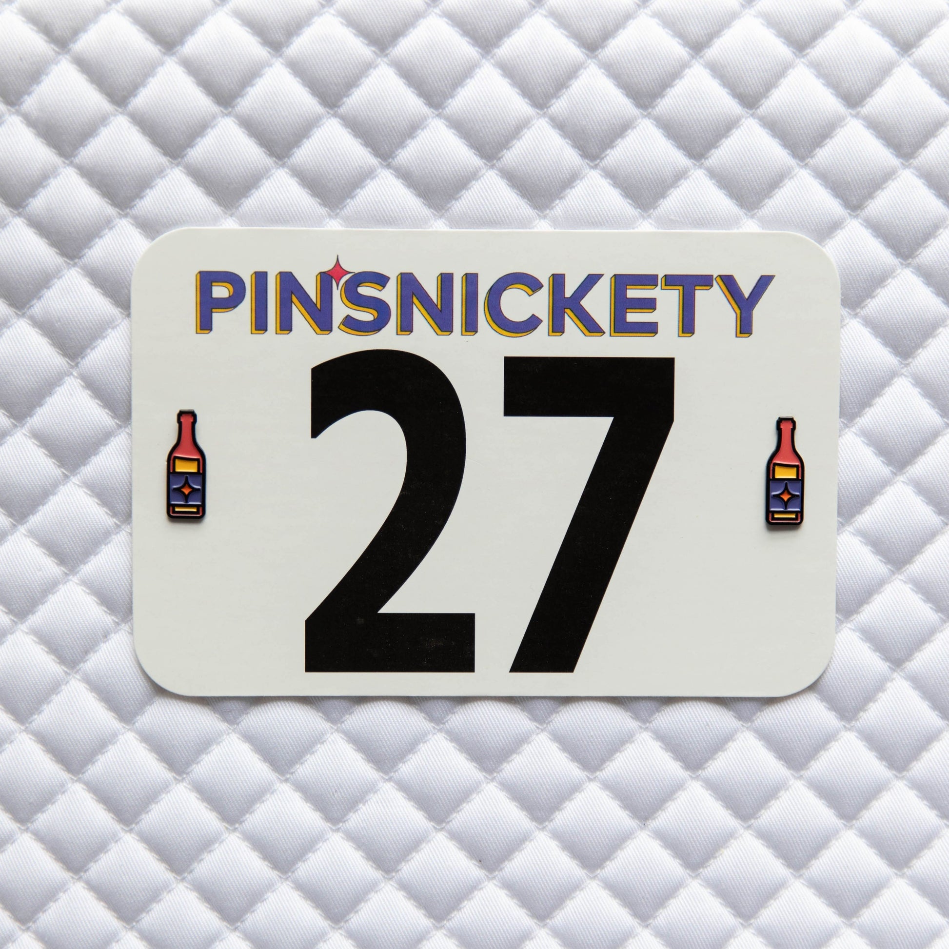 Pinsnickety Hot Sauce horse show number pins on a saddle pad