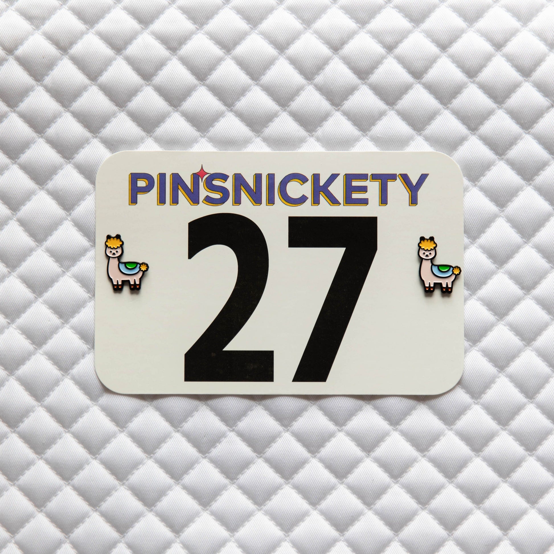 Pinsnickety Drama Llama horse show number pins on a saddle pad