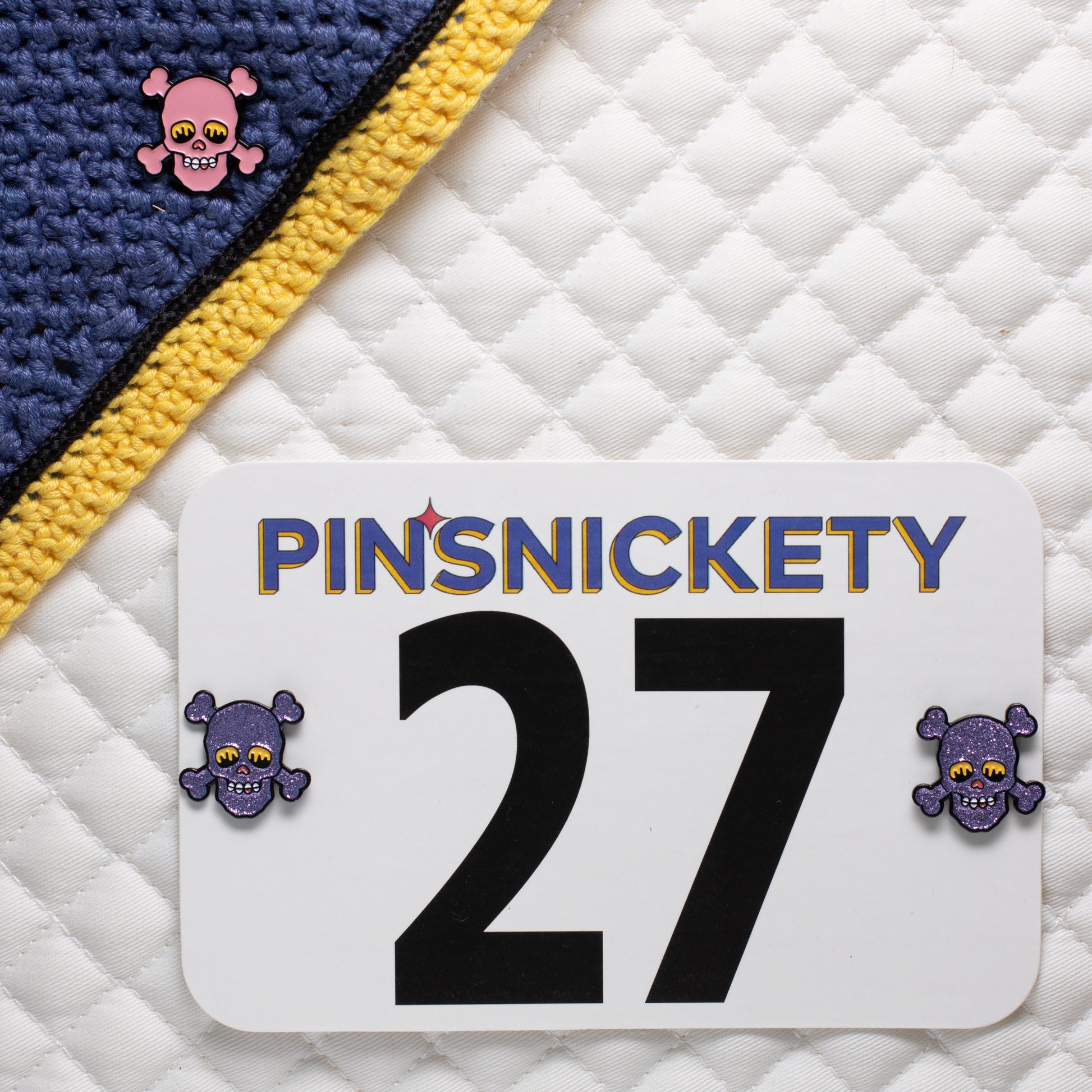 pinsnickety skull horse show number pins on a saddle pad and bonnet in glitter purple and special edition pink