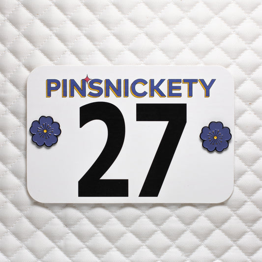 pinsnickety purple poppy horse show number pins on a saddle pad