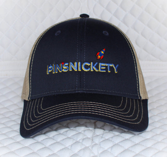 Front view of Pinsnickety's trucker hat. Our cap comes with a mini rocket pin attached. 