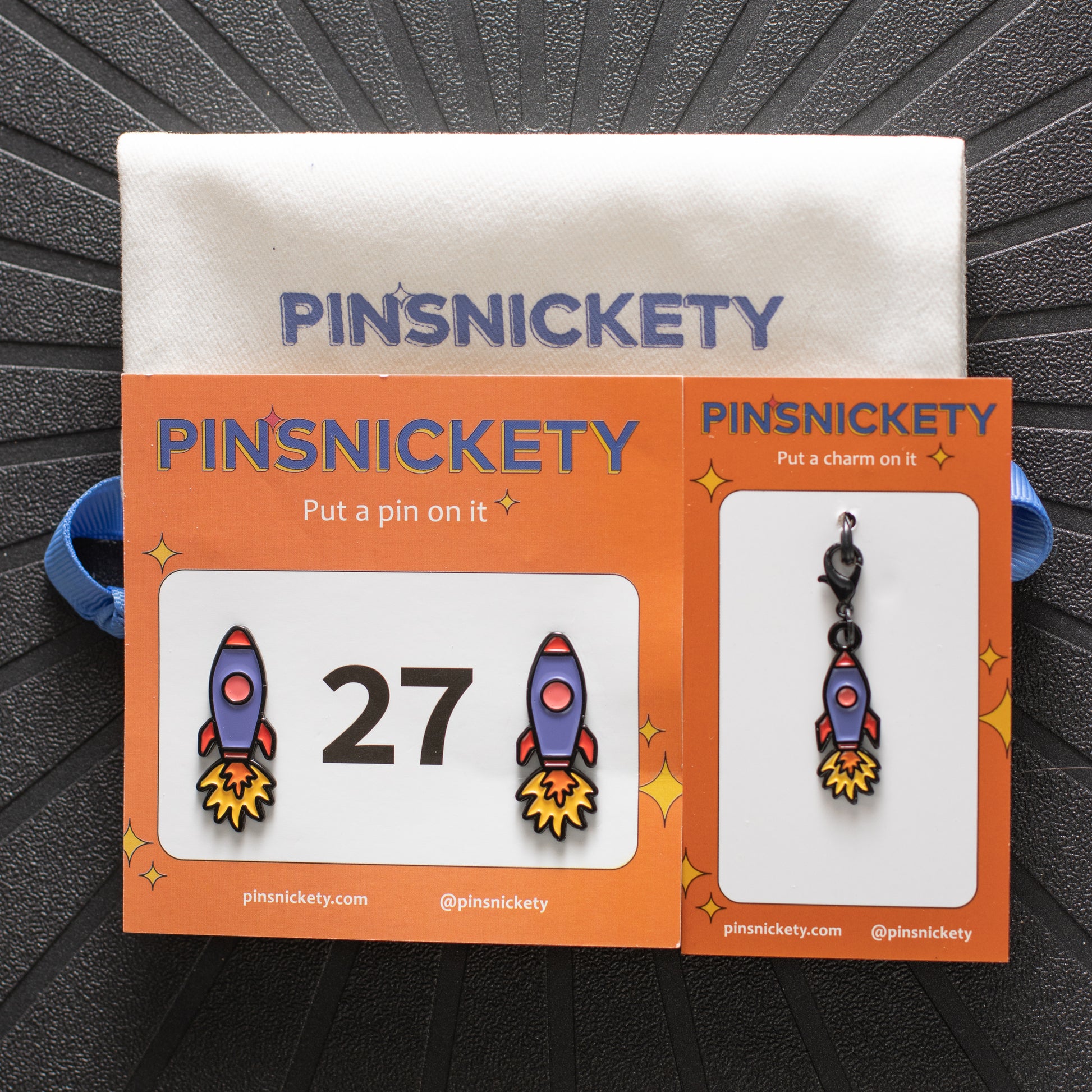 Pinsnickety rocket ship horse show number pins and charm on their product packaging cards