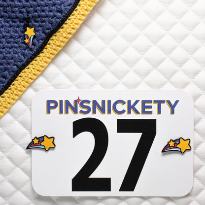 Pinsnickety shooting star charm and horse show number pins on a bonnet and a saddle pad