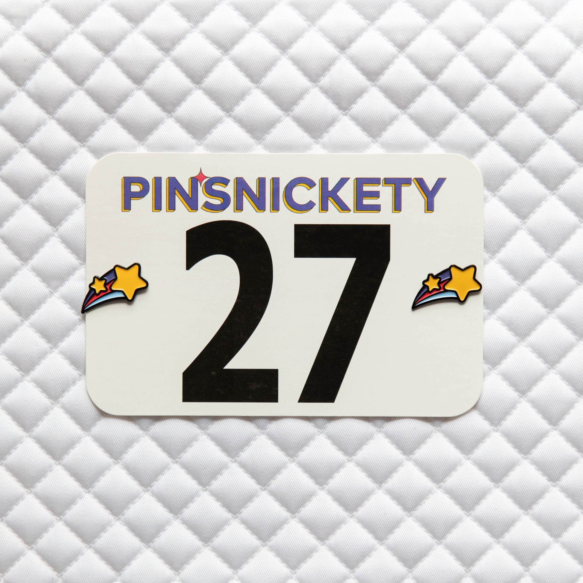 Pinsnickety Shooting Star horse show number pins on a saddle pad