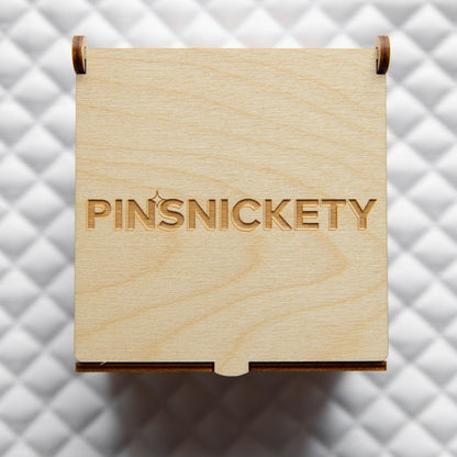 Pinsnickety's "Tack" Trunk closed, showing Pinsnickety brand engraving on the lid