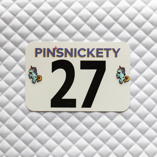 Pinsnickety Flying Unicorn horse show number pins on a saddle pad