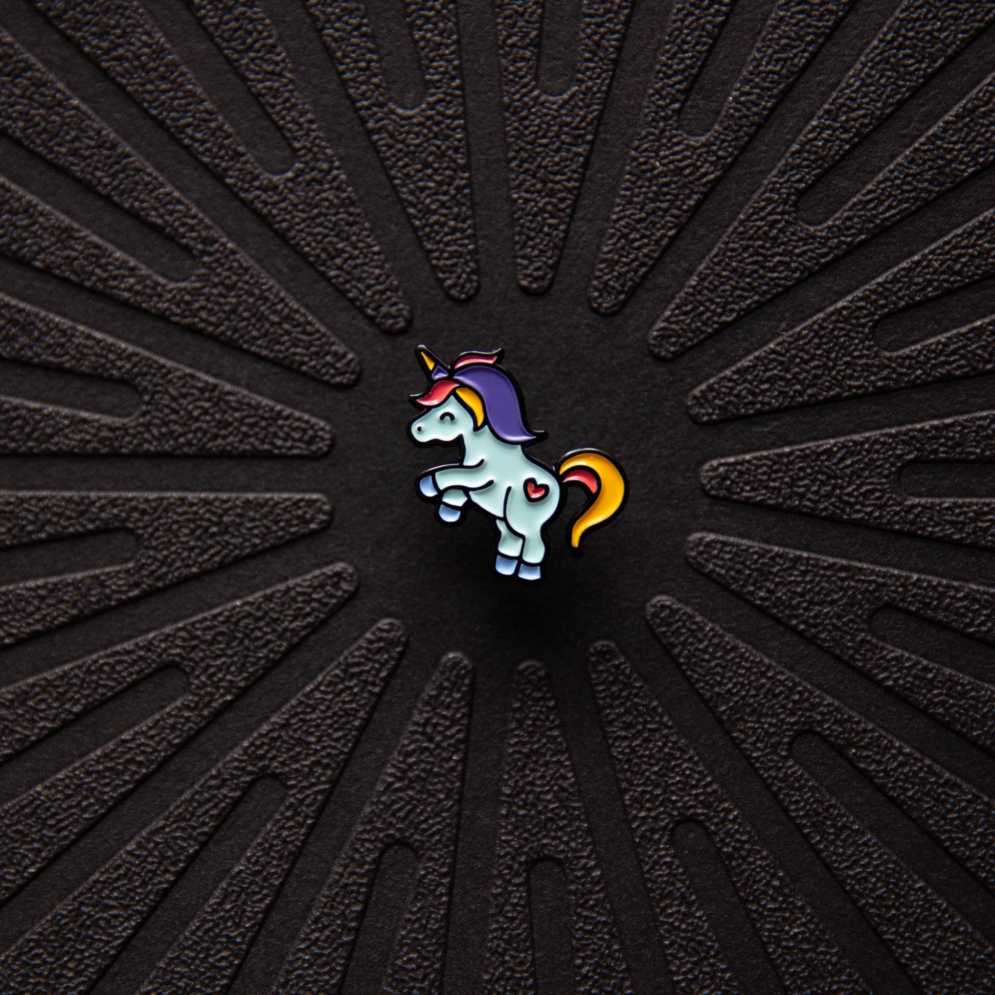 Close up view of Pinsnickety Flying Unicorn horse show number pin.